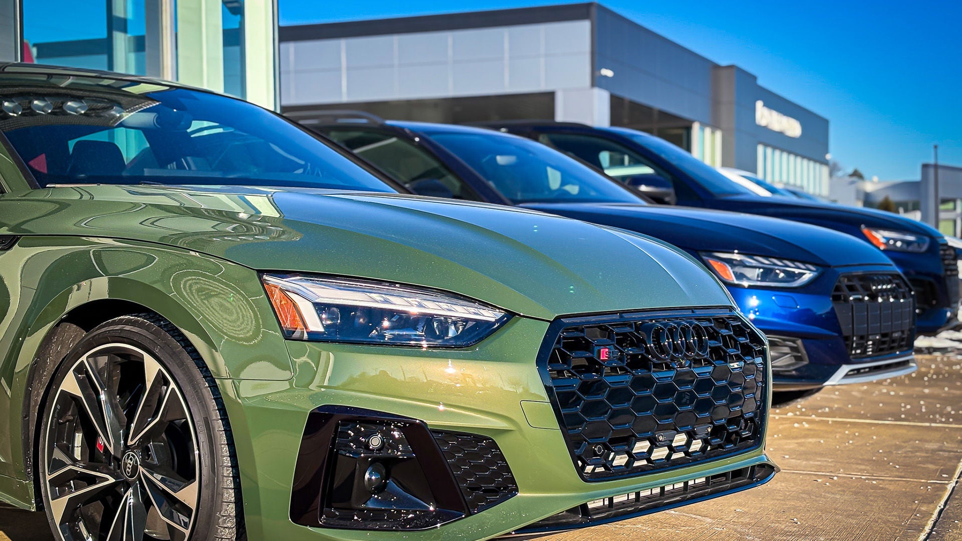 Three quarter view of an Audi parked.